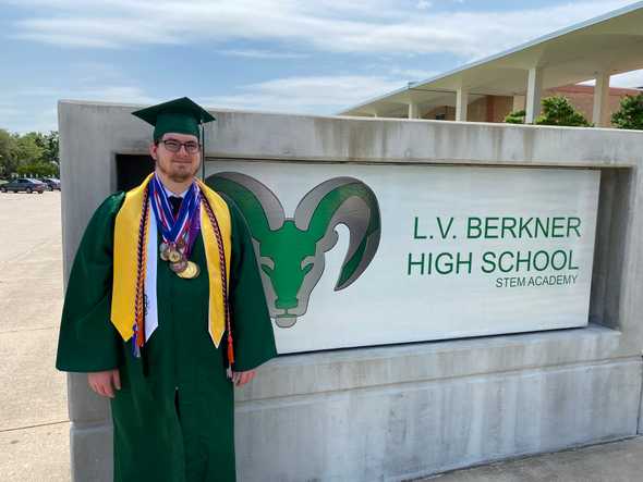 Isaac posing in front of L.V. Berkner High School